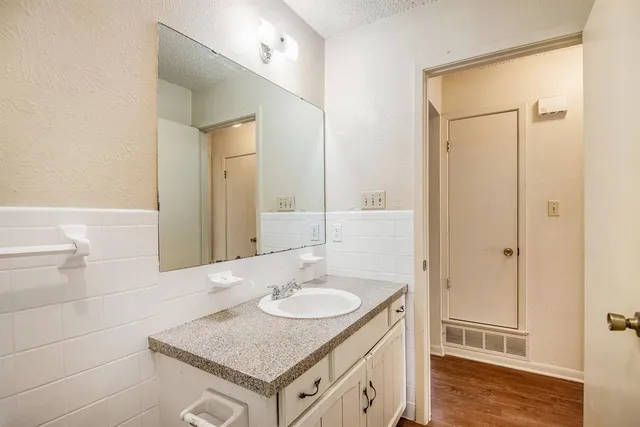 a bathroom with a granite countertop sink toilet and shower