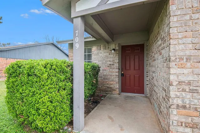 a view of house with potted plants