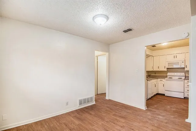 a view of a kitchen with wooden floor and stove top oven