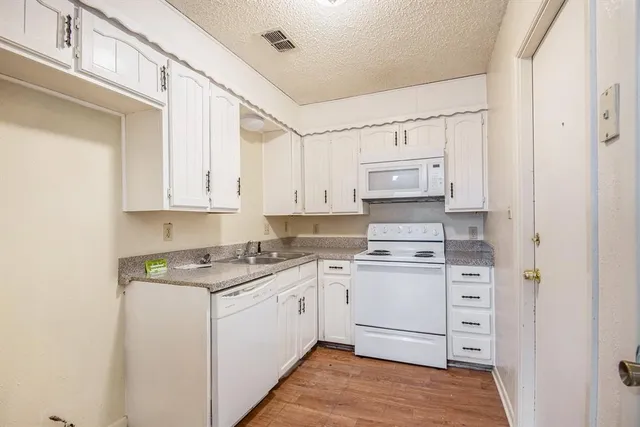 a kitchen with stainless steel appliances granite countertop a sink and cabinets