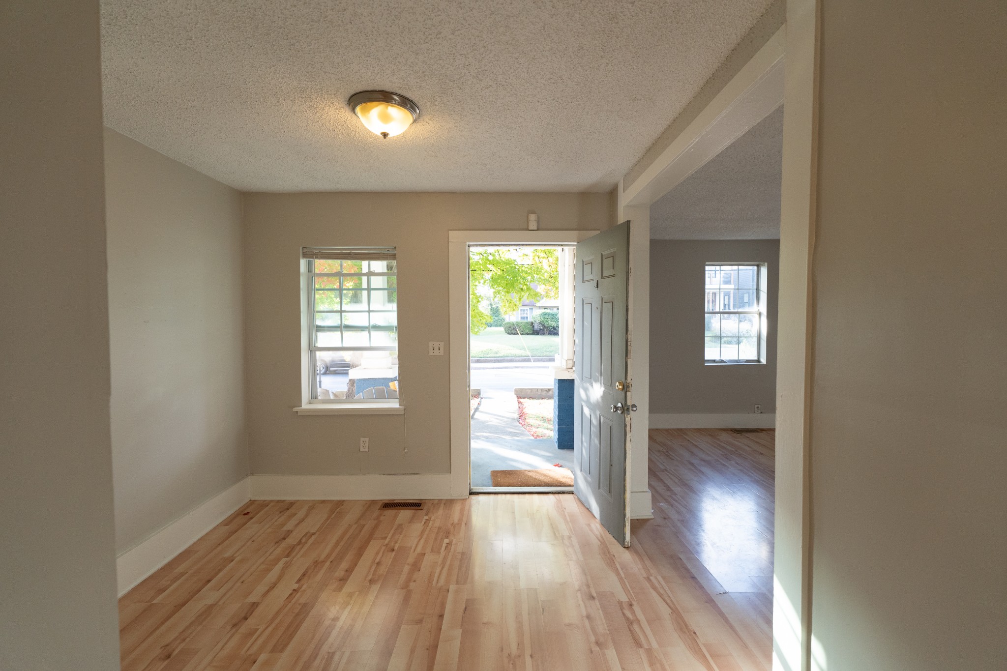 909 Lischey Avenue Nashville, TN 37207 - Photo 4 of 9 a view of an empty room with wooden floor and a window