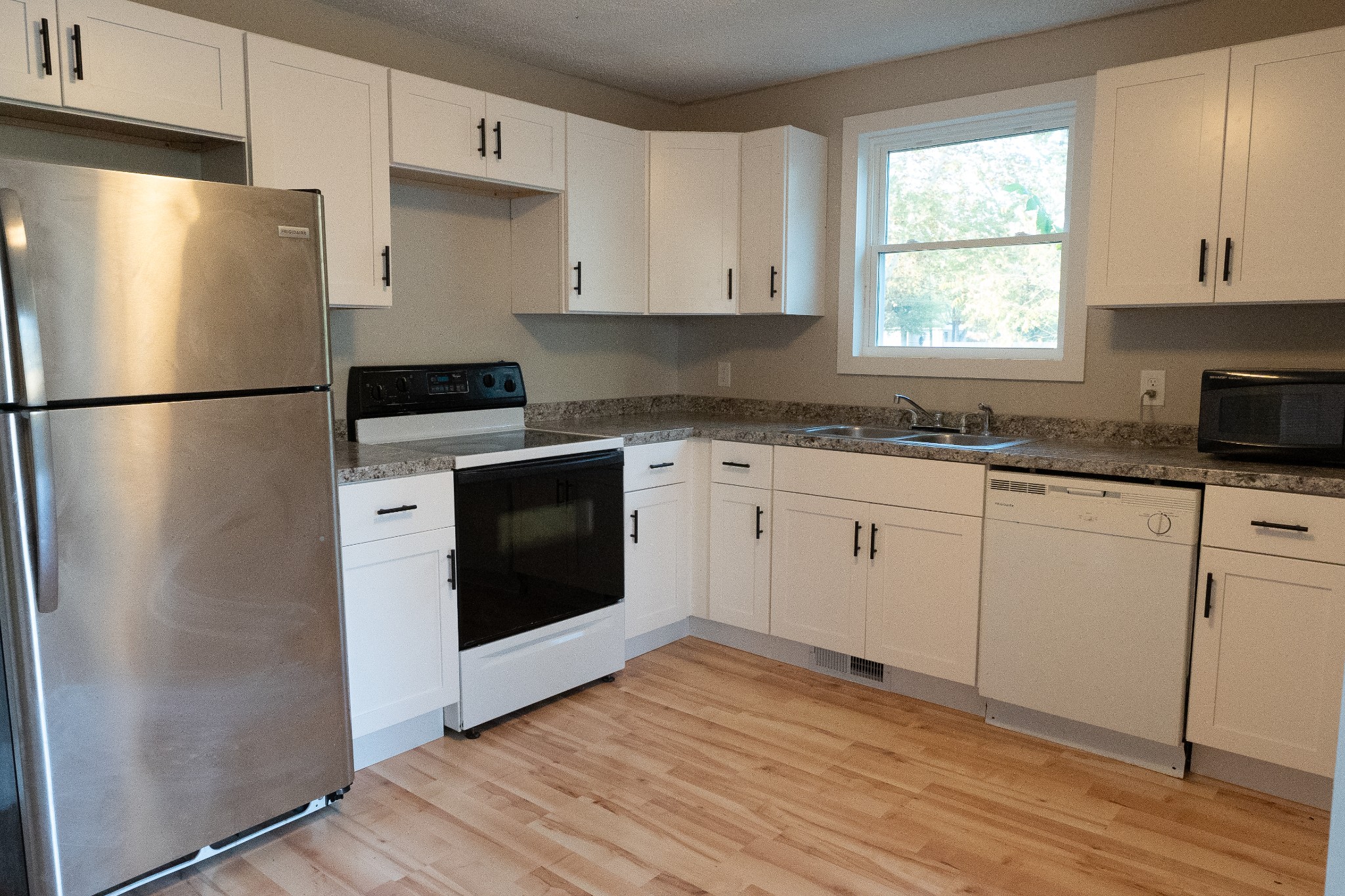 909 Lischey Avenue Nashville, TN 37207 - Photo 5 of 9 a kitchen with a refrigerator sink and cabinets