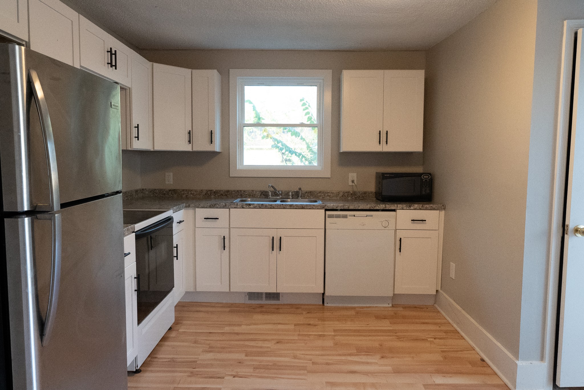 909 Lischey Avenue Nashville, TN 37207 - Photo 6 of 9 a kitchen with a refrigerator sink and cabinets
