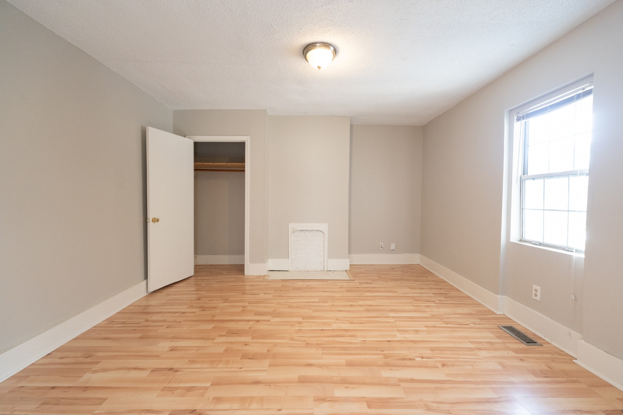 909 Lischey Avenue Nashville, TN 37207 - Photo 9 of 9 a view of an empty room with wooden floor and a window