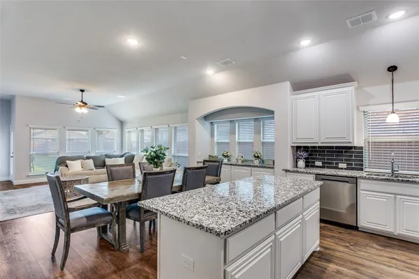 a kitchen with center island table and chairs in it