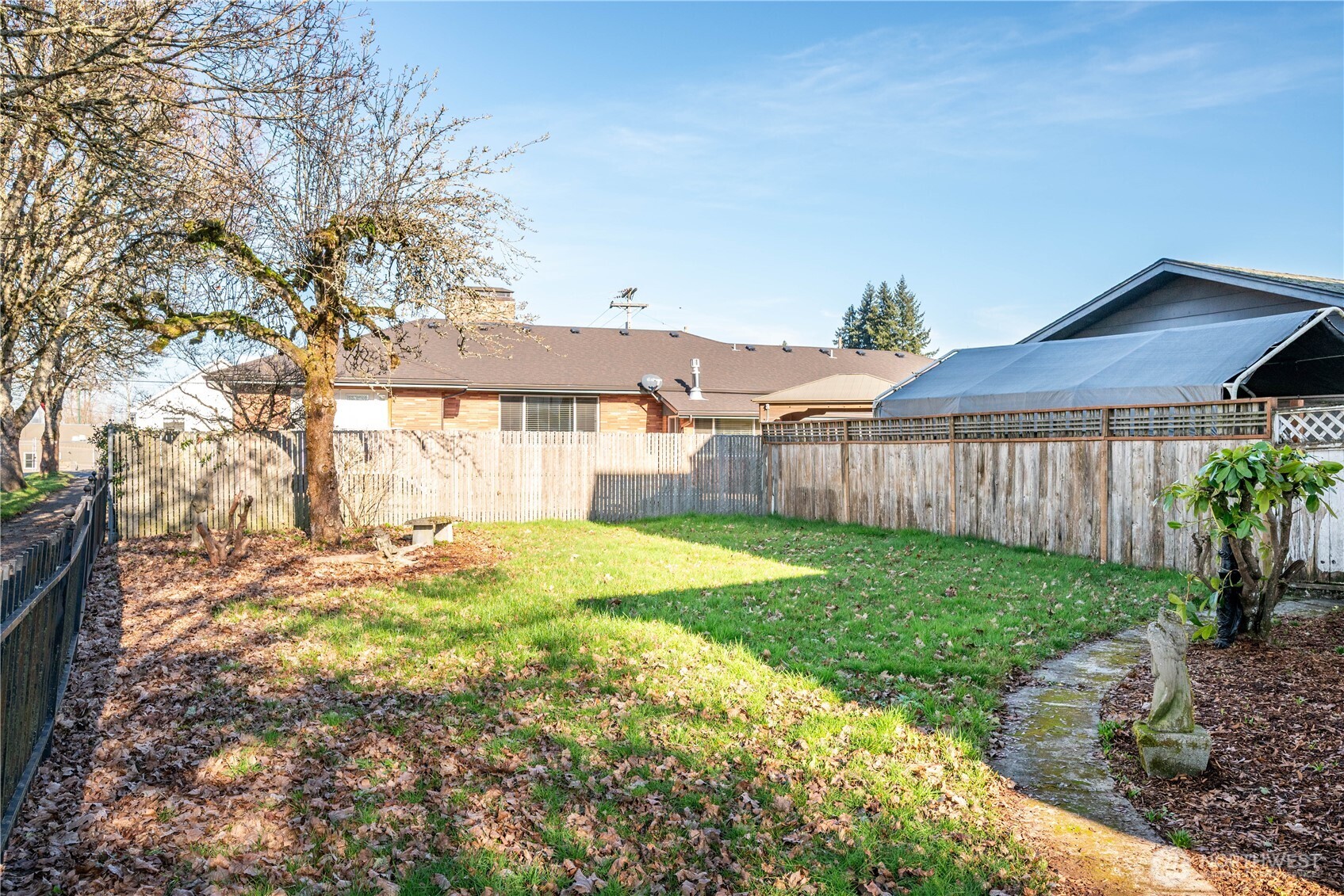 136 3rd Avenue Southwest Castle Rock, WA 98611 - Photo 26 of 40 a view of a backyard with table and chairs and wooden fence