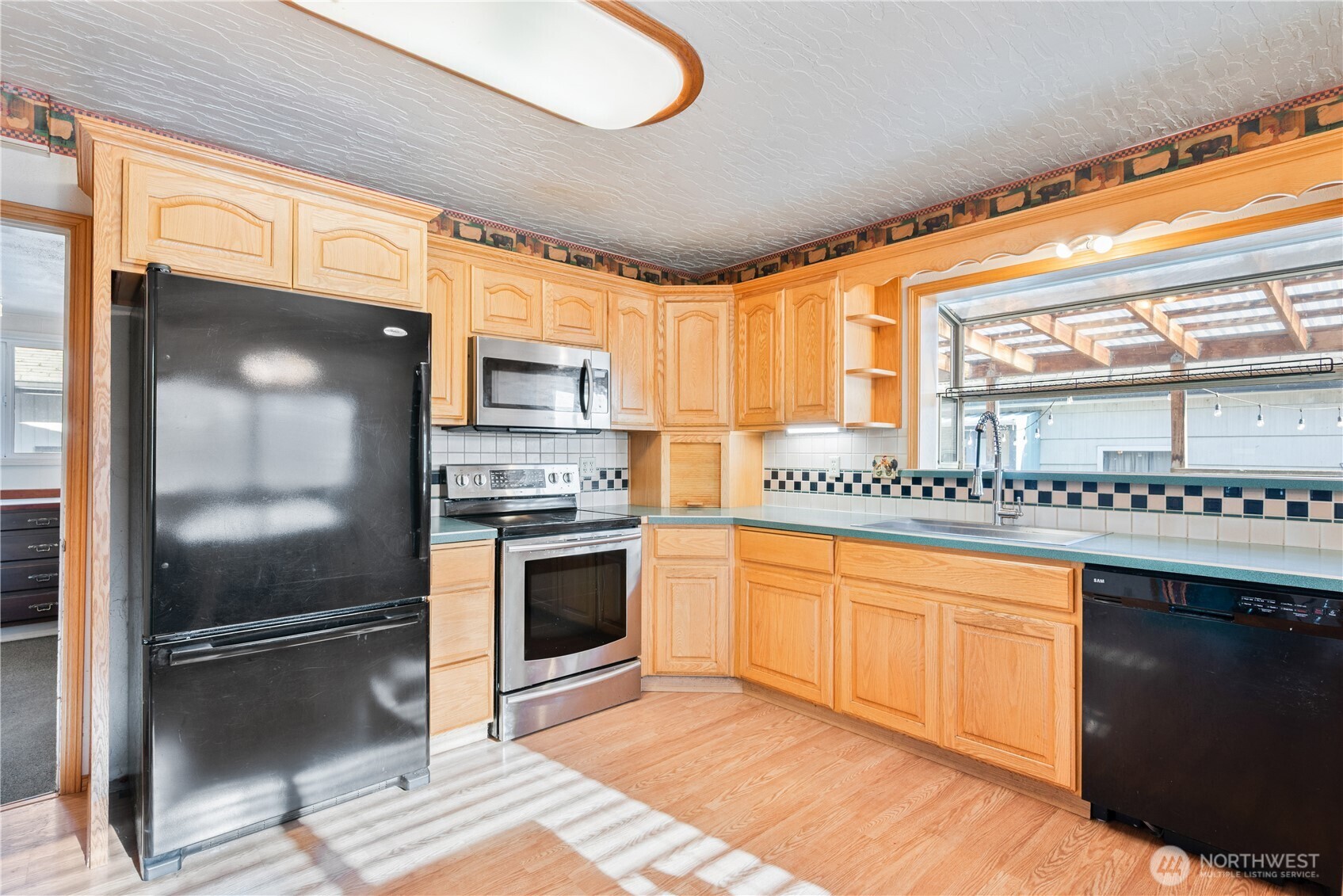136 3rd Avenue Southwest Castle Rock, WA 98611 - Photo 8 of 39 a kitchen with stainless steel appliances granite countertop a stove a sink and a refrigerator