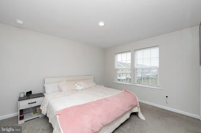 a bedroom with a large tv and a bed