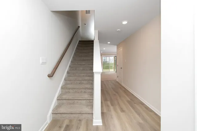 a view of entryway and hall with wooden floor