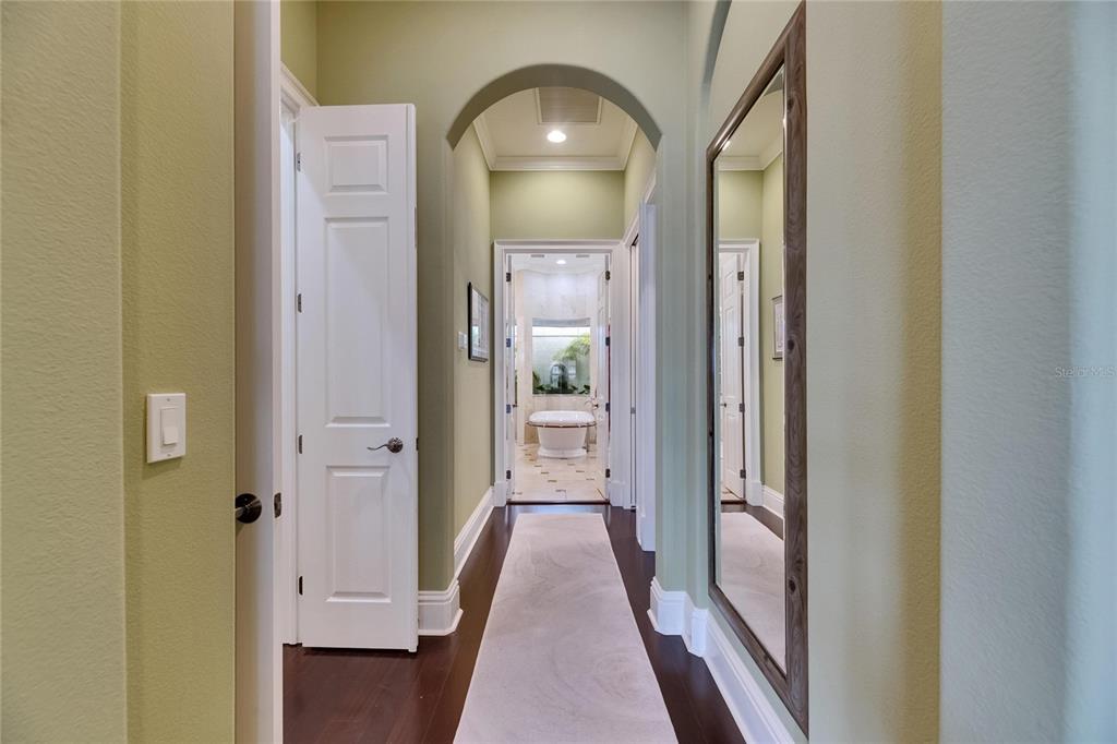 624 Balibay Road Apollo Beach, FL 33572 - Photo 50 of 99 a view of a hallway with wooden floor and a bathroom