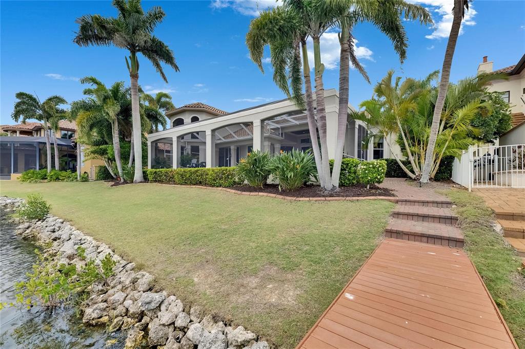 624 Balibay Road Apollo Beach, FL 33572 - Photo 88 of 99 a front view of a house with a yard and potted plants