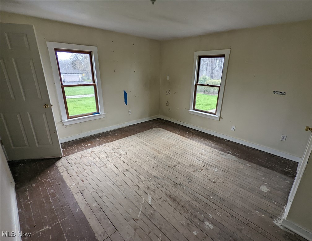 355 West Calla Road North Lima, OH 44452 - Photo 11 of 13 Unfurnished room with plenty of natural light, dark wood finished floors, and baseboards