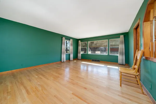 a view of a kitchen with stainless steel appliances wooden floor and a window