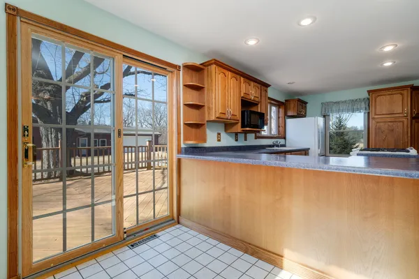 a kitchen with stainless steel appliances granite countertop a stove a sink dishwasher and a refrigerator