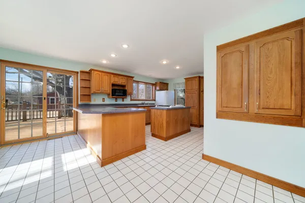 a large kitchen with a sink and cabinets