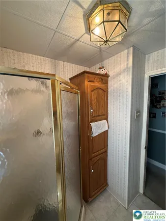 a bathroom with a glass shower door and a sink