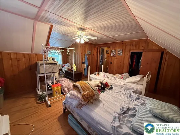 a bedroom with furniture and a wooden floor