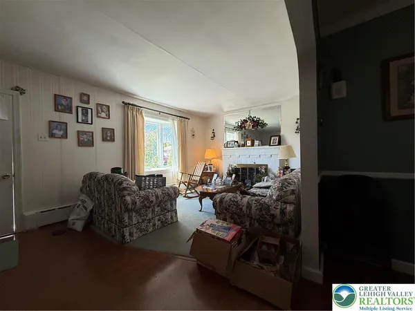 a living room with furniture a fireplace and a window