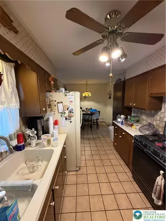 a kitchen with a sink appliances and cabinets