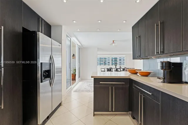 a kitchen with stainless steel appliances granite countertop a refrigerator and a sink