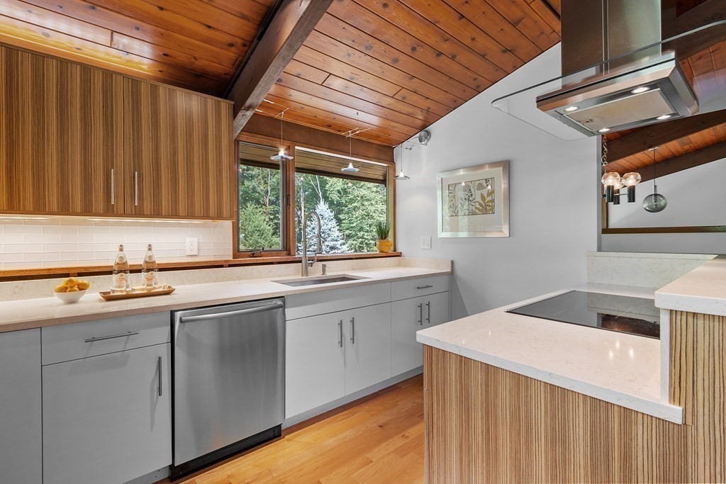 237 Stoney Gate Carlisle, MA 01741 - Photo 12 of 35 a kitchen with sink cabinets and wooden floor