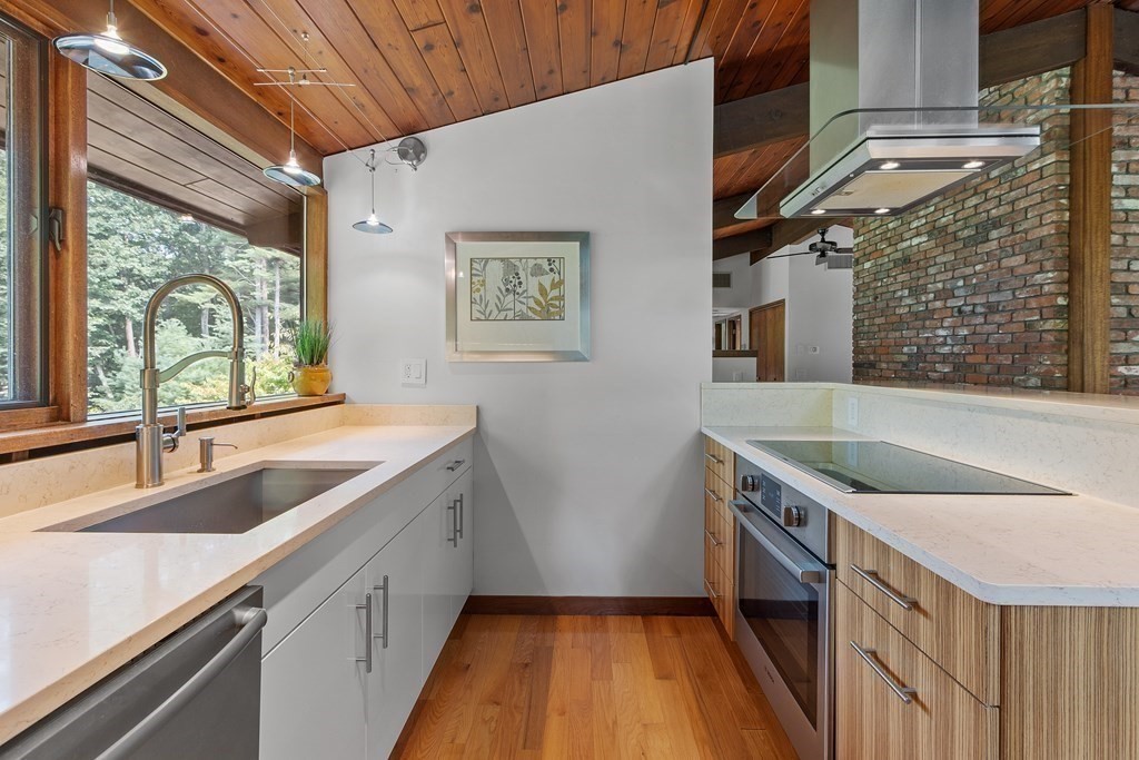 237 Stoney Gate Carlisle, MA 01741 - Photo 13 of 35 a bathroom with a granite countertop sink a large mirror and shower