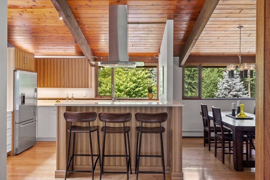 237 Stoney Gate Carlisle, MA 01741 - Photo 14 of 35 a dining room with a window and chairs