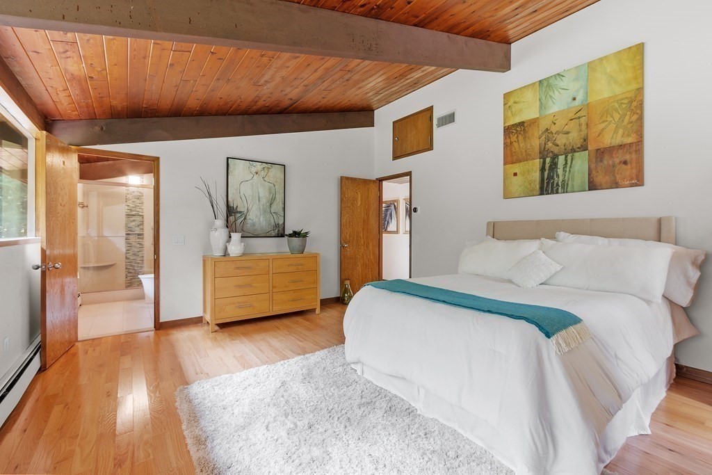 237 Stoney Gate Carlisle, MA 01741 - Photo 19 of 35 a bedroom with a bed and a couch