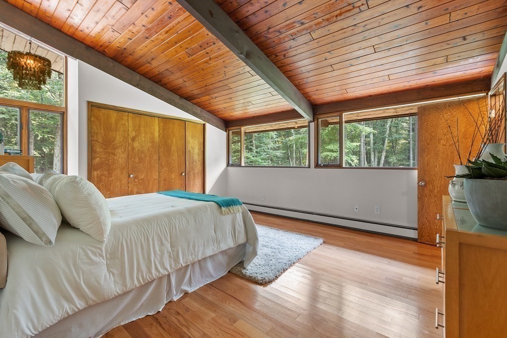 237 Stoney Gate Carlisle, MA 01741 - Photo 20 of 35 a bedroom with a bed and wooden floor