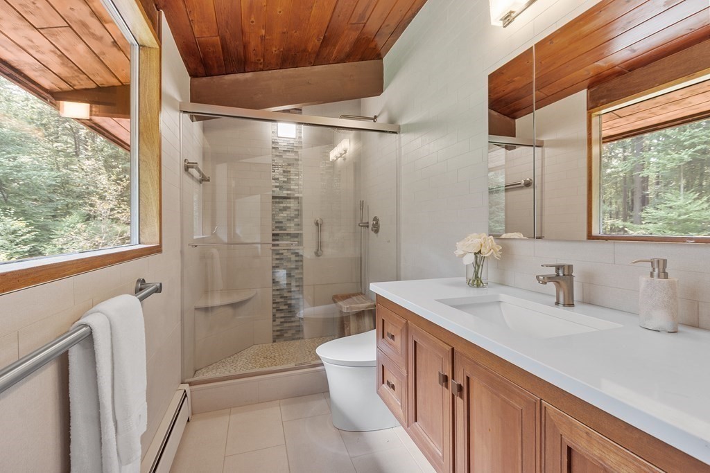 237 Stoney Gate Carlisle, MA 01741 - Photo 21 of 35 a bathroom with a double vanity sink toilet and shower