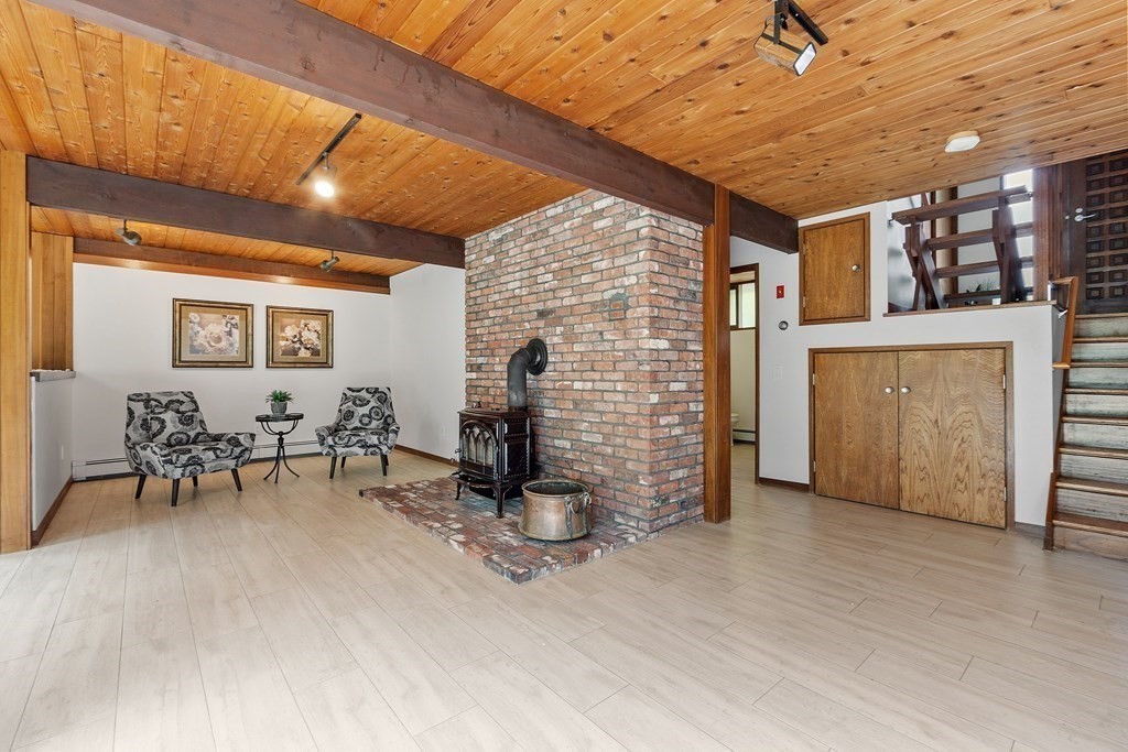 237 Stoney Gate Carlisle, MA 01741 - Photo 25 of 35 a view of a livingroom with furniture and a ceiling fan