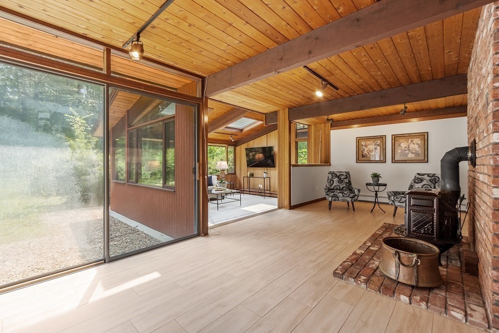 237 Stoney Gate Carlisle, MA 01741 - Photo 26 of 35 a view of a livingroom with furniture and a window
