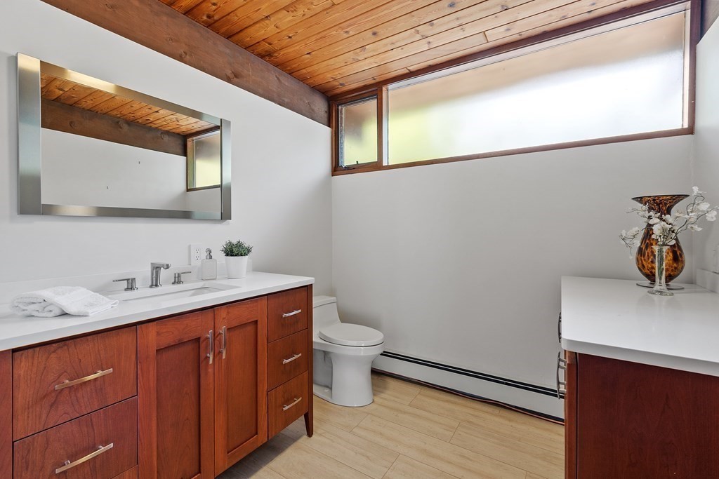 237 Stoney Gate Carlisle, MA 01741 - Photo 30 of 35 a bathroom with a sink a toilet and mirror