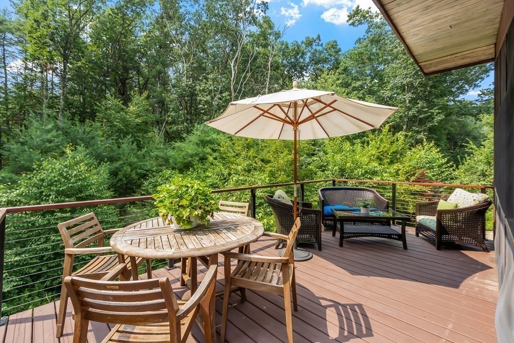 237 Stoney Gate Carlisle, MA 01741 - Photo 9 of 35 an outdoor space with furniture and umbrella