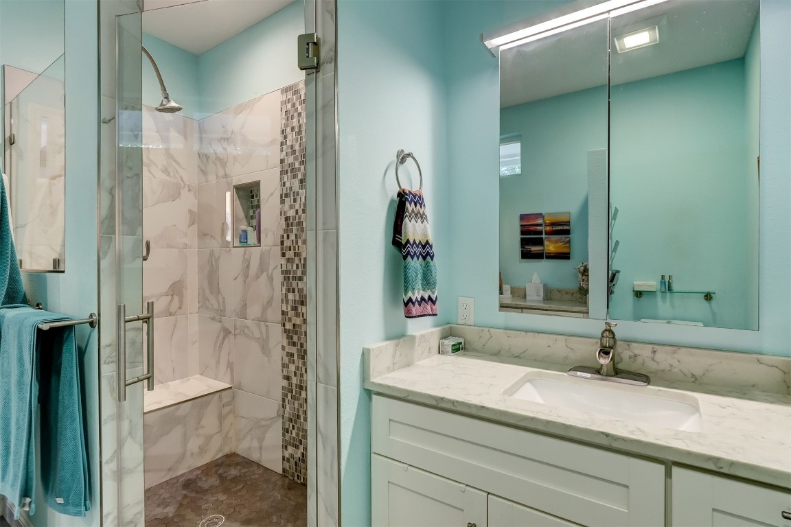 2629 Racheal Avenue Fernandina Beach, FL 32034 - Photo 18 of 53 a bathroom with a granite countertop sink a mirror and shower