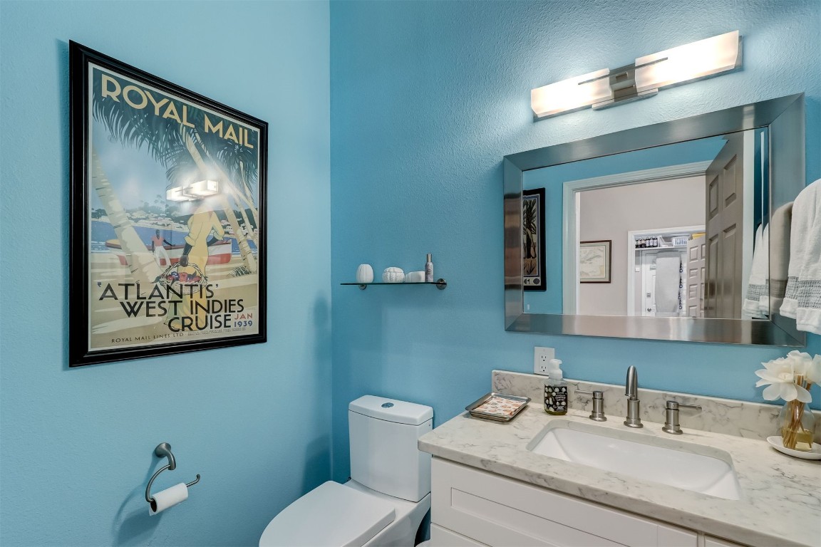 2629 Racheal Avenue Fernandina Beach, FL 32034 - Photo 23 of 53 a bathroom with a granite countertop toilet a sink and mirror