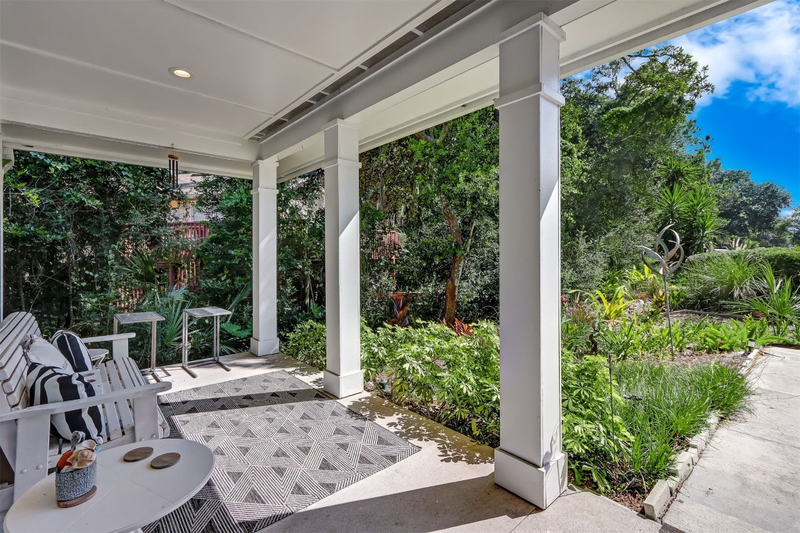 2629 Racheal Avenue Fernandina Beach, FL 32034 - Photo 3 of 53 a view of a patio with table and chairs potted plants with floor to ceiling window