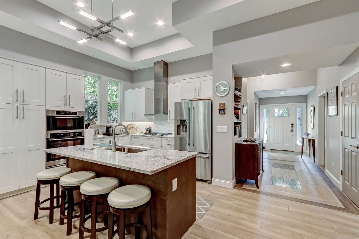 2629 Racheal Avenue Fernandina Beach, FL 32034 - Photo 7 of 53 a kitchen with stainless steel appliances granite countertop a stove refrigerator a sink dishwasher with a dining table and chairs
