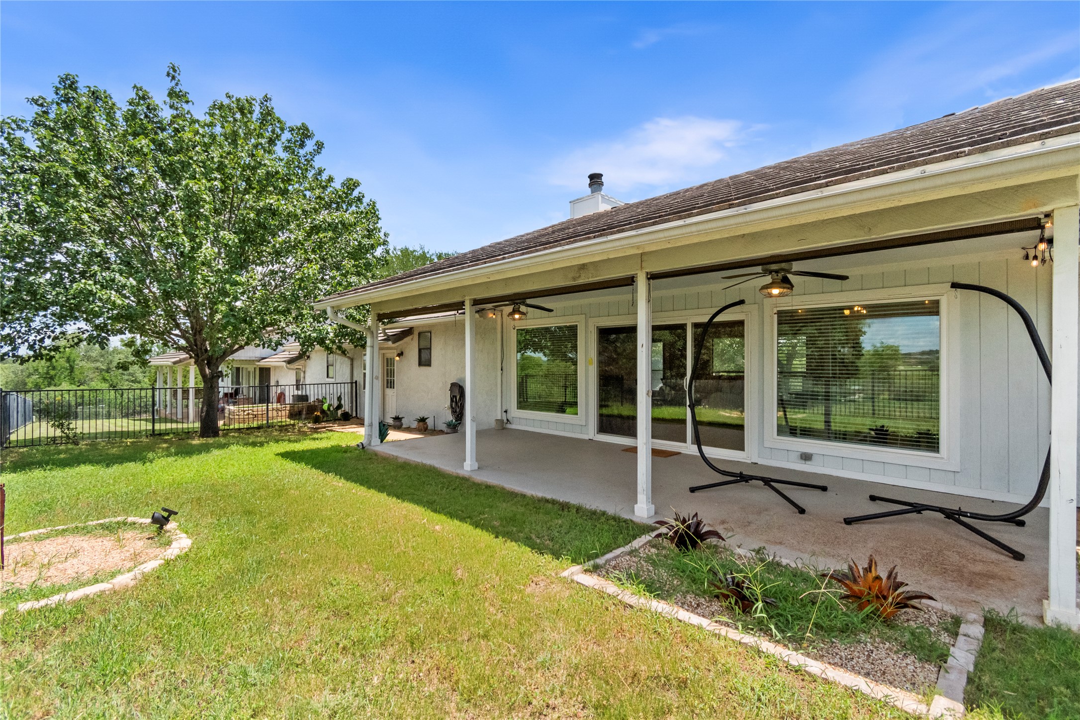 210 Teeoff, Unit B Horseshoe Bay, TX 78657 - Photo 26 of 38 A spacious covered patio provides a serene outdoor living area, overlooking a verdant lawn.