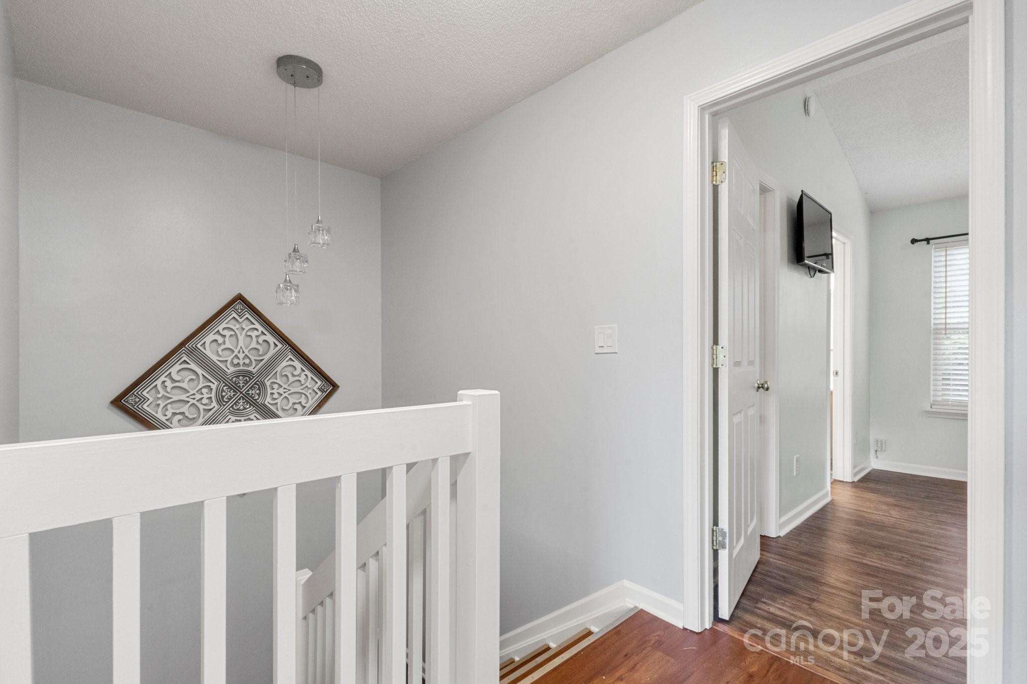 11023 Kinston Ridge Place Charlotte, NC 28273 - Photo 14 of 25 a view of a hallway to rooms and wooden floor