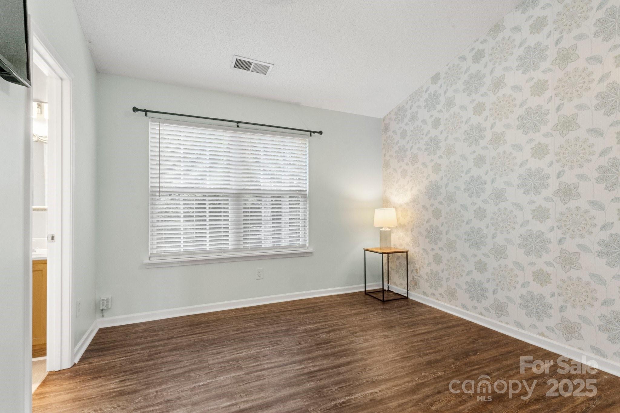 11023 Kinston Ridge Place Charlotte, NC 28273 - Photo 15 of 25 a view of empty room with wooden floor and fan