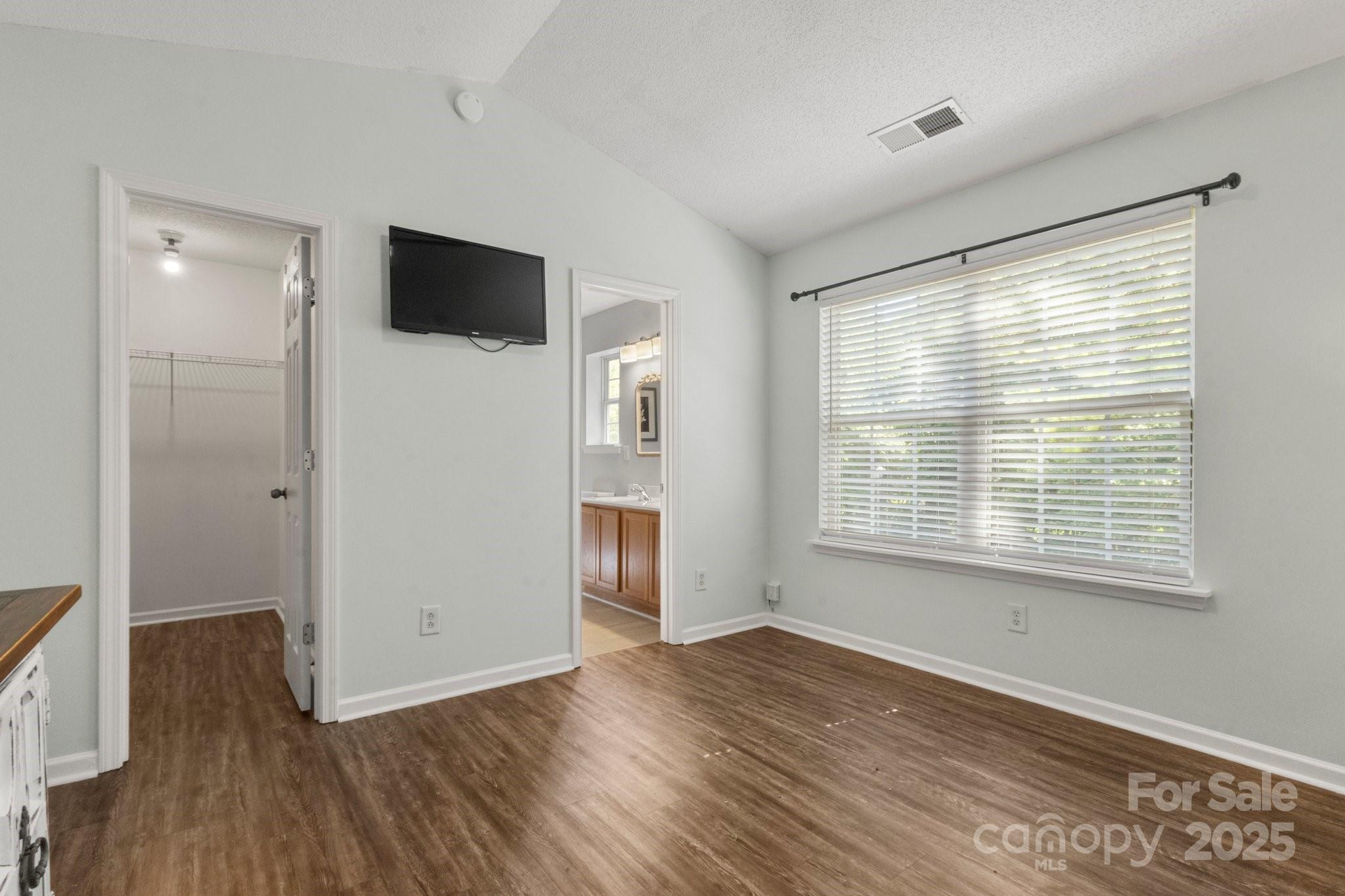 11023 Kinston Ridge Place Charlotte, NC 28273 - Photo 18 of 25 a view of a livingroom with wooden floor and a flat screen tv