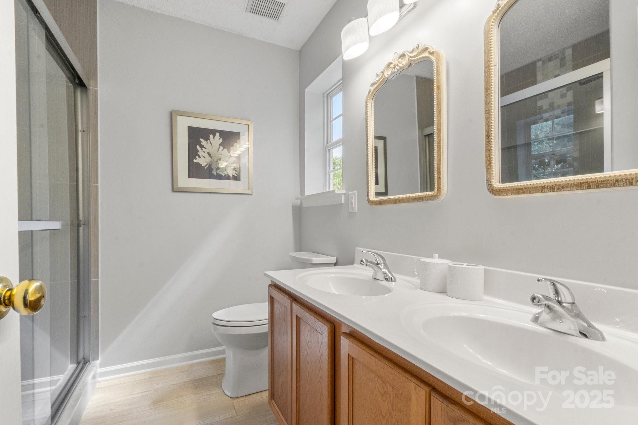 11023 Kinston Ridge Place Charlotte, NC 28273 - Photo 19 of 25 a bathroom with a granite countertop sink mirror and toilet