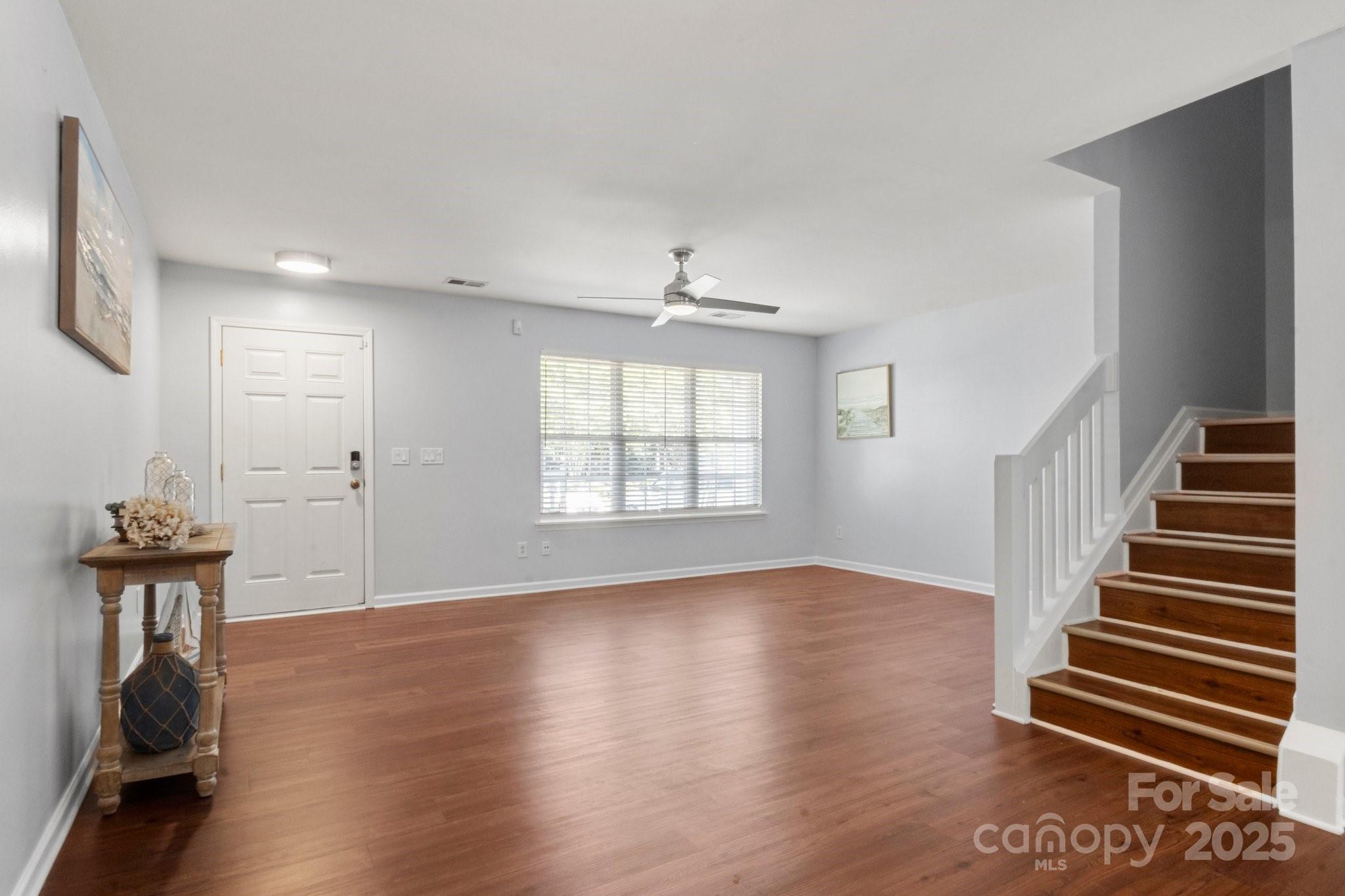 11023 Kinston Ridge Place Charlotte, NC 28273 - Photo 2 of 25 a view of an empty room with wooden floor and a window