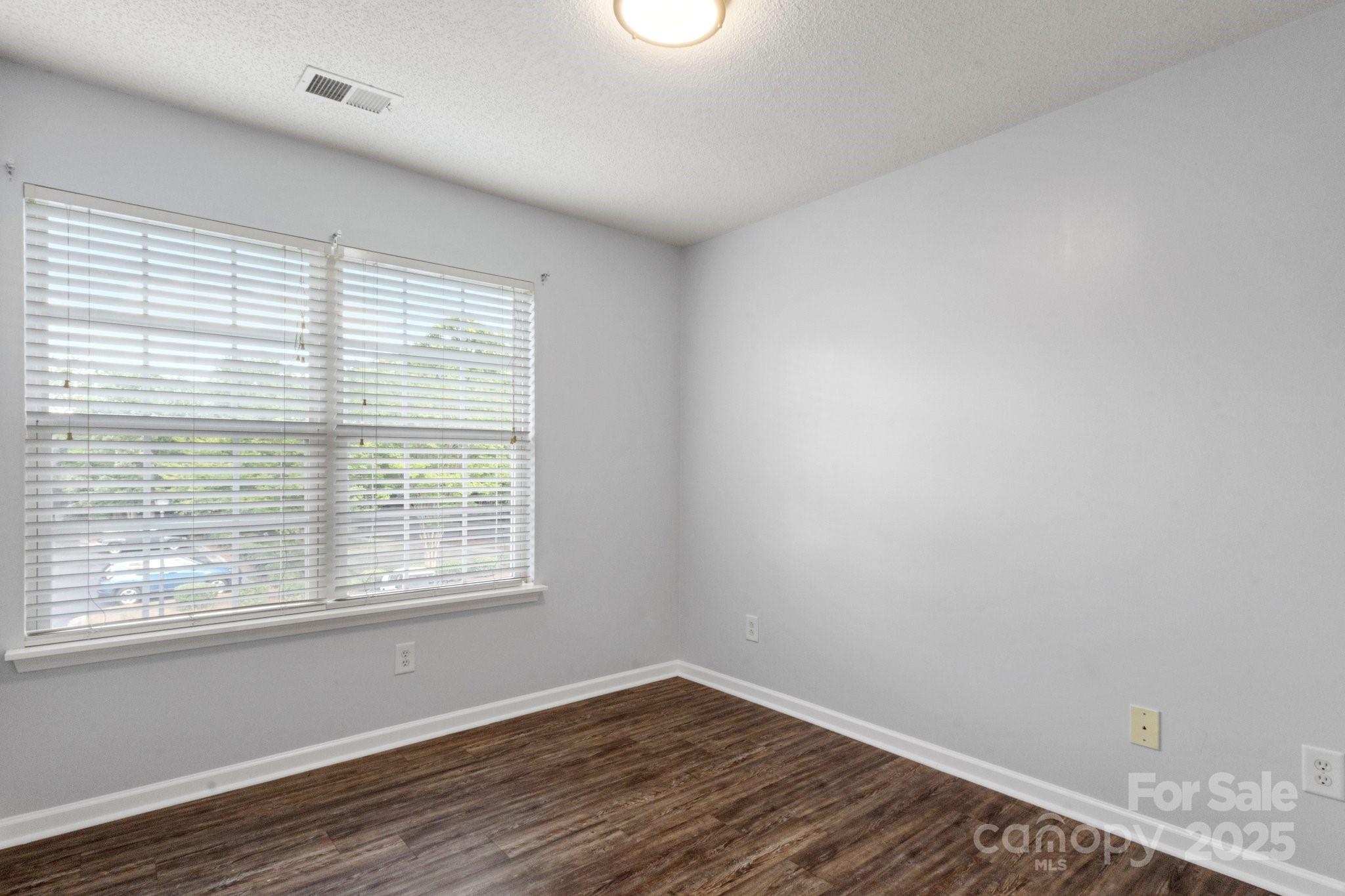 11023 Kinston Ridge Place Charlotte, NC 28273 - Photo 23 of 25 a view of a room with wooden floor and windows
