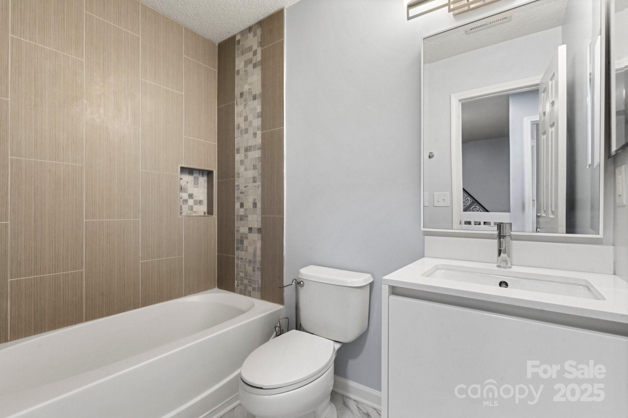 11023 Kinston Ridge Place Charlotte, NC 28273 - Photo 24 of 25 a bathroom with a toilet a sink and bathtub
