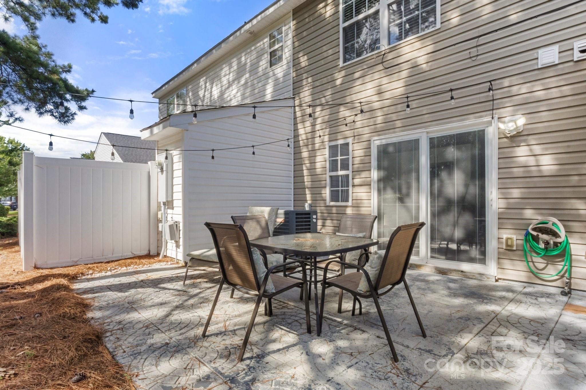 11023 Kinston Ridge Place Charlotte, NC 28273 - Photo 25 of 25 a view of a patio with table and chairs and potted plants