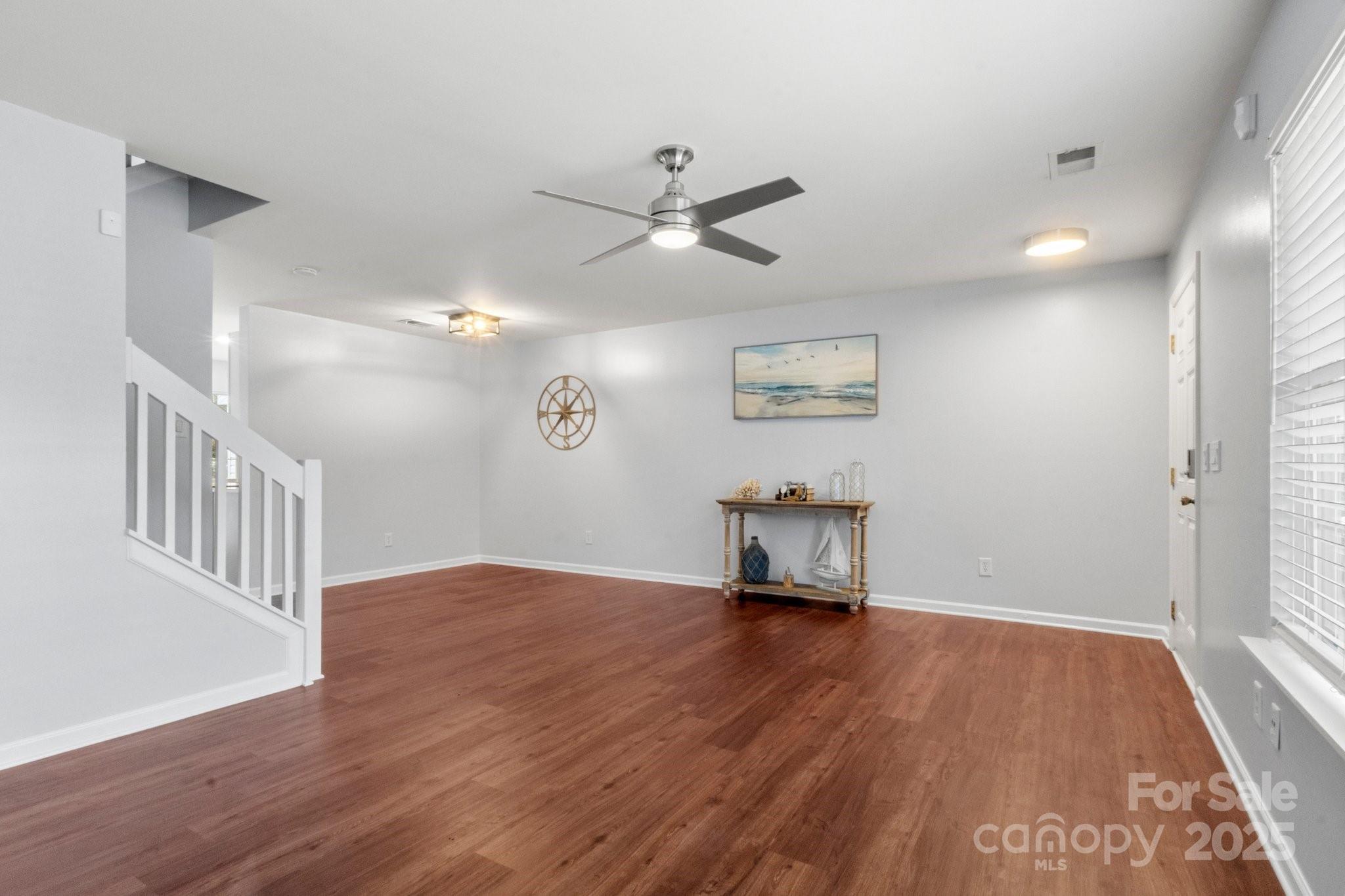 11023 Kinston Ridge Place Charlotte, NC 28273 - Photo 3 of 25 a view of an empty room with a window and wooden floor