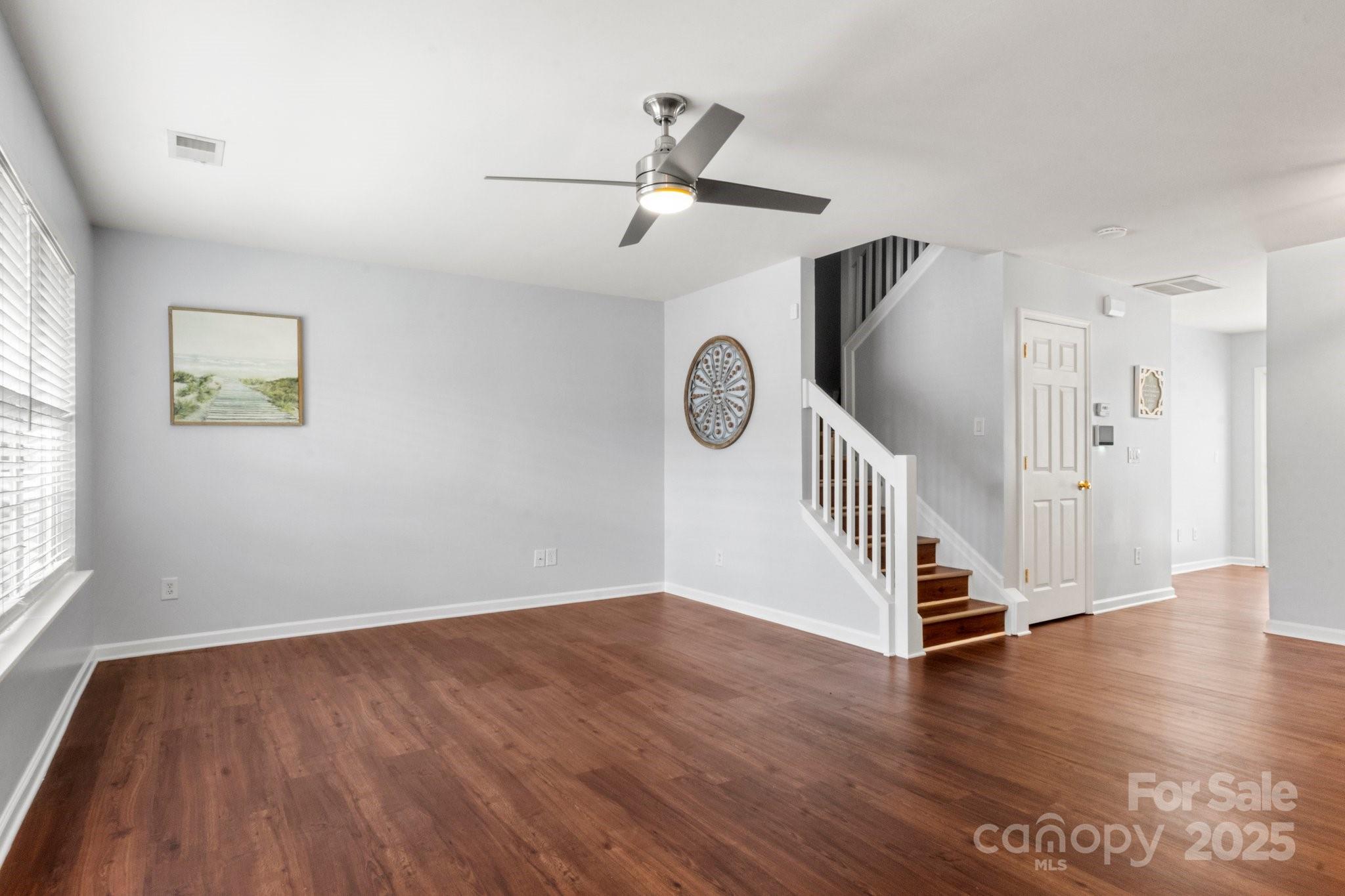 11023 Kinston Ridge Place Charlotte, NC 28273 - Photo 4 of 25 a view of a hallway with wooden floor and staircase