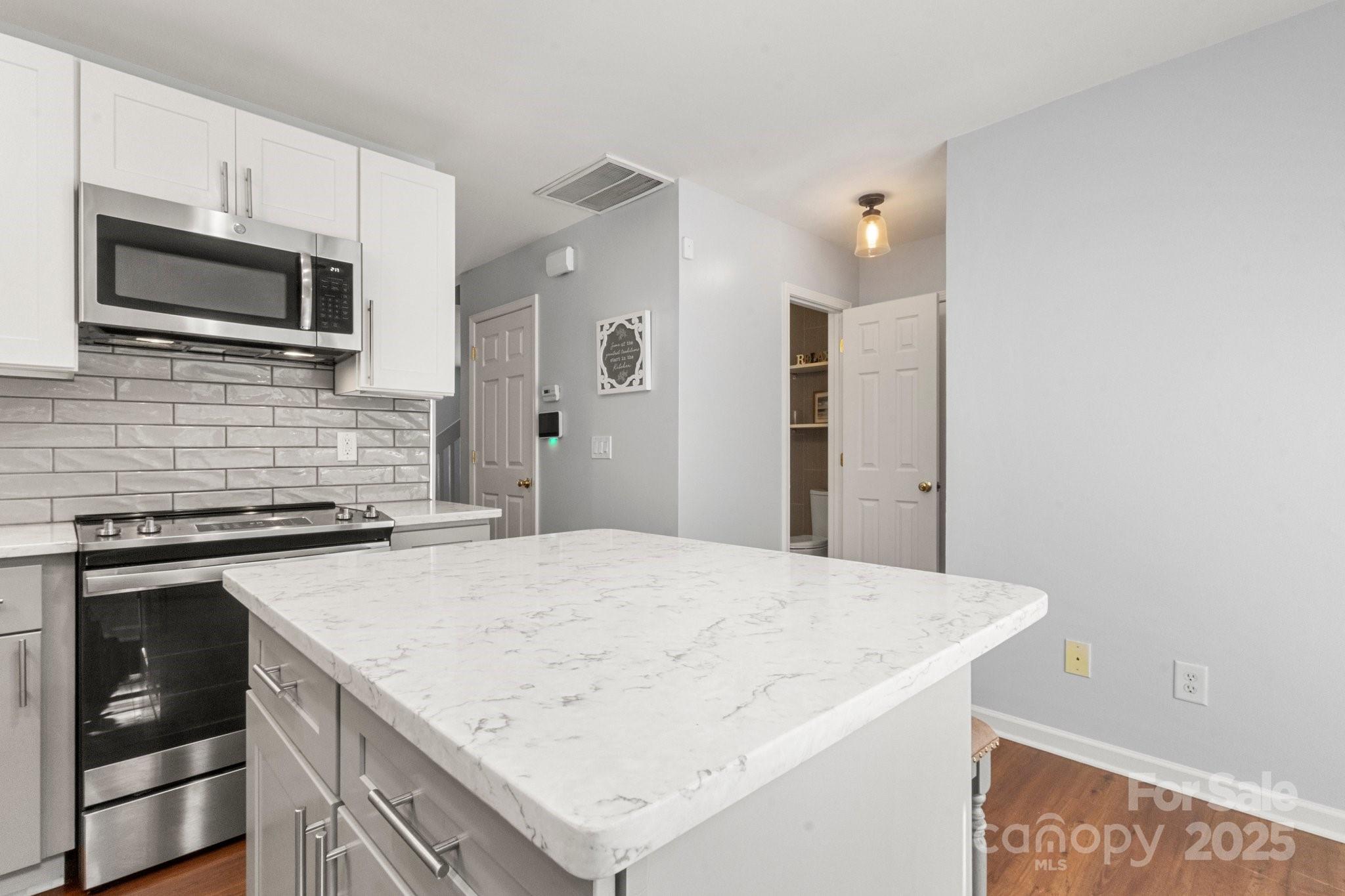 11023 Kinston Ridge Place Charlotte, NC 28273 - Photo 10 of 25 a kitchen with a stove and a microwave
